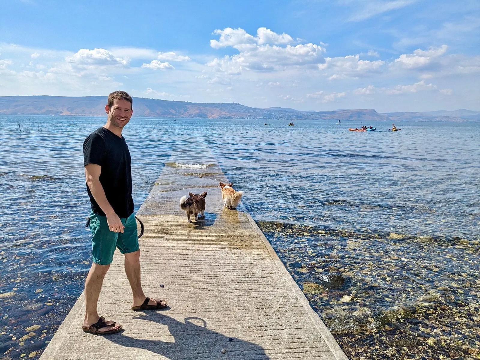 Gal Bareket beside the water with his two dogs